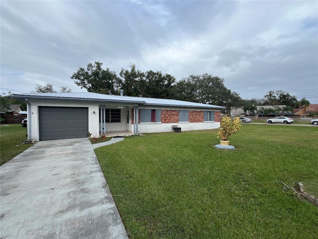 single story home with a front yard and a garage