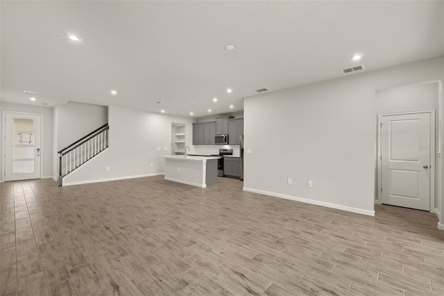 unfurnished living room with light wood-type flooring