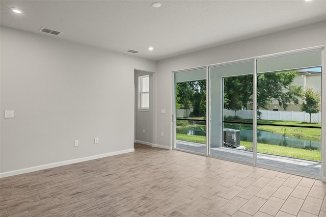 empty room with light hardwood / wood-style flooring