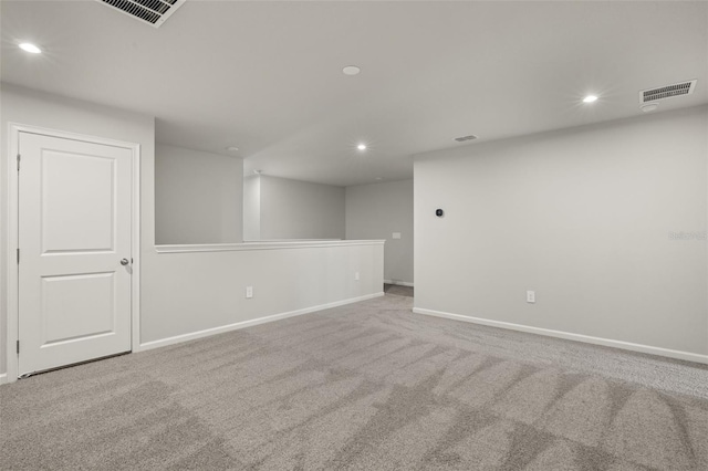 spare room featuring light colored carpet