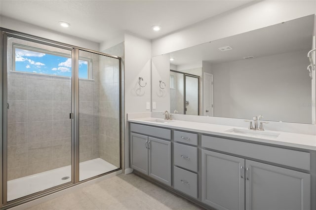 bathroom with tile patterned floors, vanity, and an enclosed shower