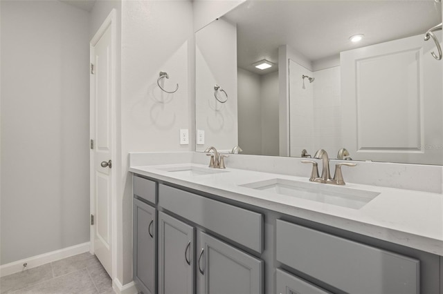 bathroom with tile patterned flooring, vanity, and walk in shower