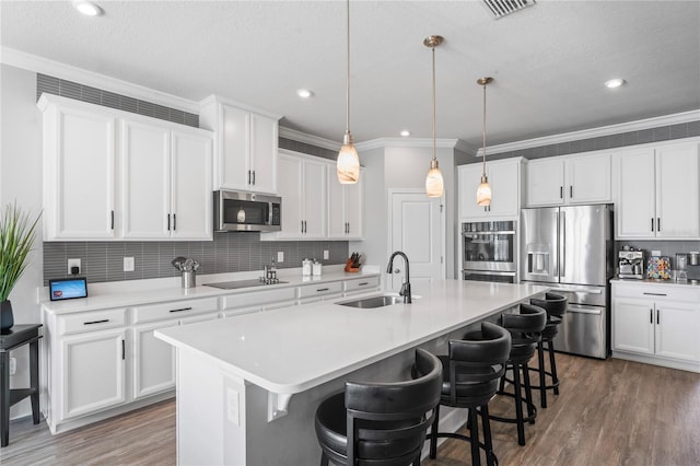 kitchen with white cabinetry, sink, and stainless steel appliances