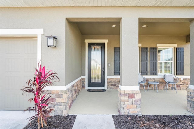 view of exterior entry with covered porch