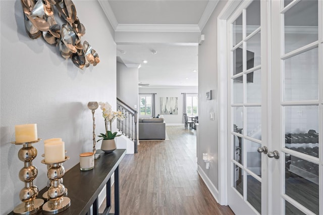 hall featuring french doors, hardwood / wood-style flooring, and crown molding