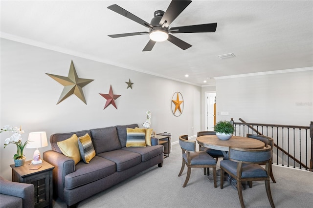 living room with ceiling fan, carpet floors, and crown molding