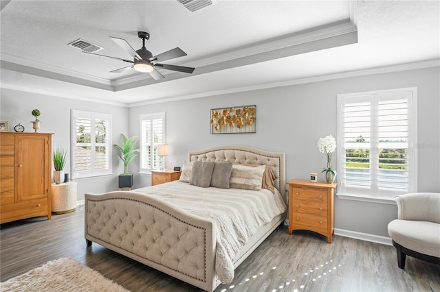 bedroom with dark hardwood / wood-style flooring, ceiling fan, and crown molding