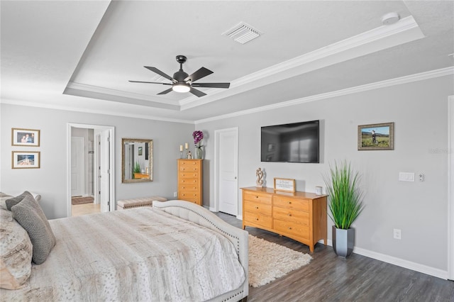 bedroom featuring dark hardwood / wood-style floors, a raised ceiling, ceiling fan, and crown molding