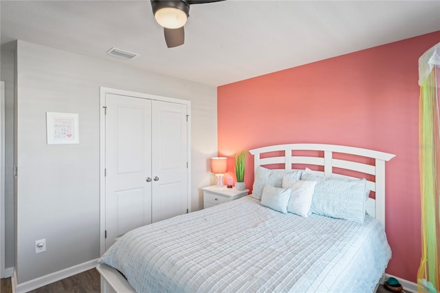 bedroom featuring dark hardwood / wood-style flooring, a closet, and ceiling fan