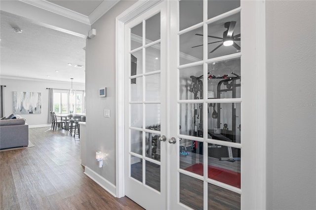 interior space with hardwood / wood-style floors, french doors, and ornamental molding