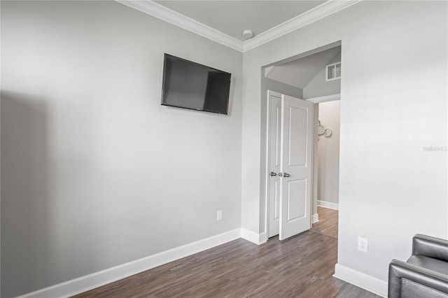 unfurnished room with ornamental molding, dark wood-type flooring, and vaulted ceiling