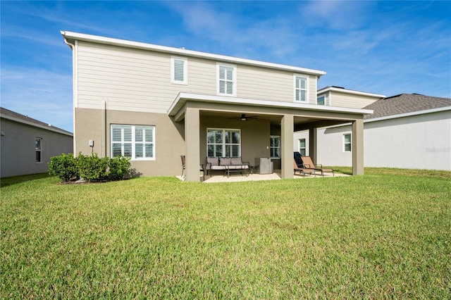 back of house with ceiling fan, a patio area, an outdoor living space, and a yard