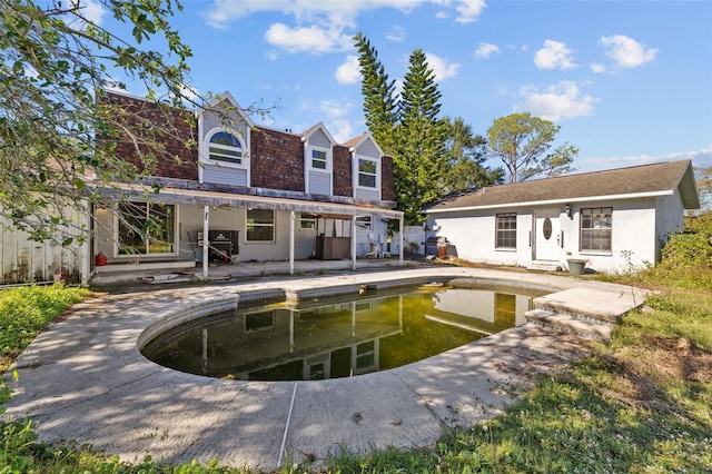 back of property featuring a patio