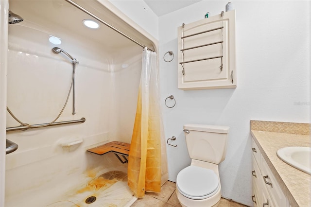 bathroom featuring tile patterned floors, vanity, toilet, and curtained shower