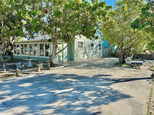 obstructed view of property featuring a sunroom