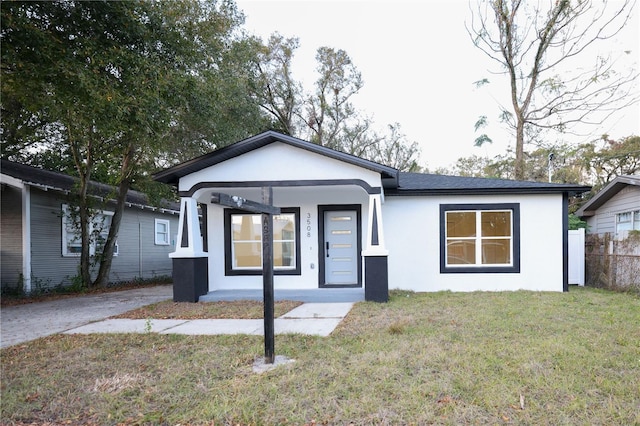 view of front facade with covered porch and a front lawn