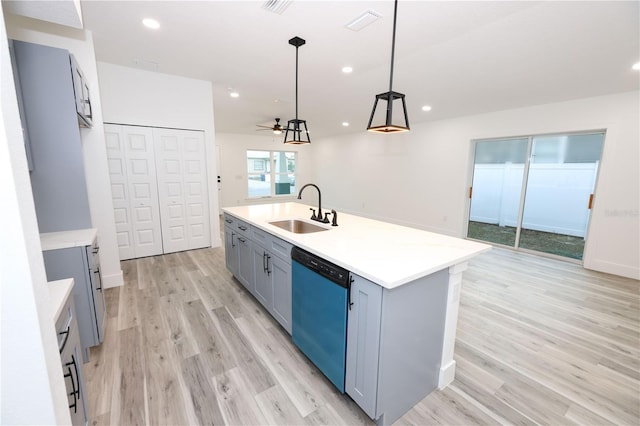 kitchen with sink, hanging light fixtures, light hardwood / wood-style flooring, dishwasher, and an island with sink