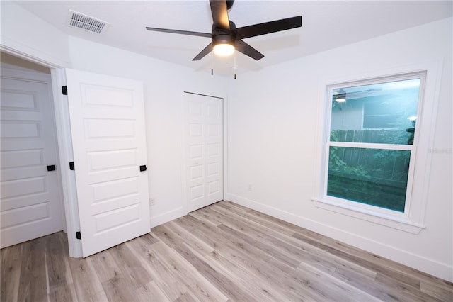 unfurnished bedroom with a closet, ceiling fan, and light wood-type flooring