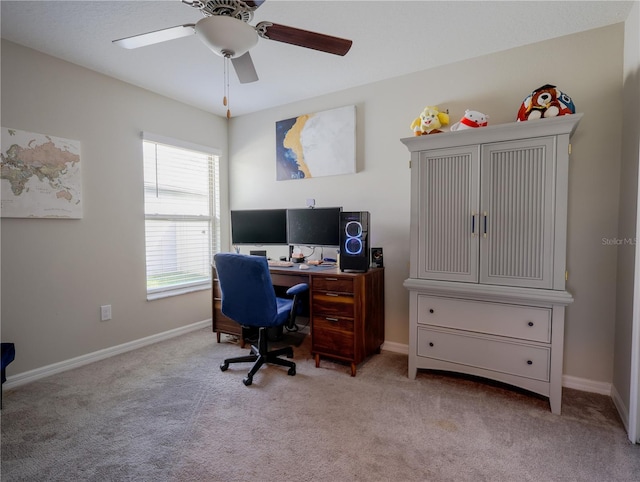 carpeted office space with ceiling fan