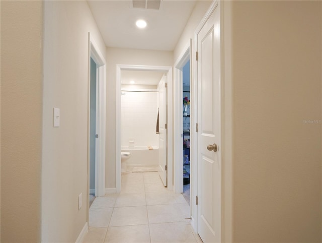 corridor with light tile patterned floors