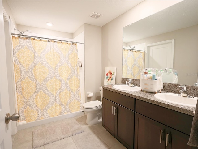 bathroom with tile patterned floors, vanity, curtained shower, and toilet