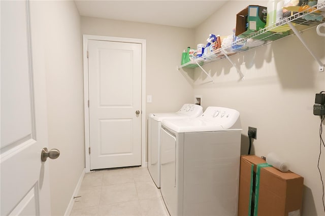 washroom featuring separate washer and dryer and light tile patterned flooring