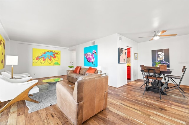 living room with hardwood / wood-style floors and ceiling fan