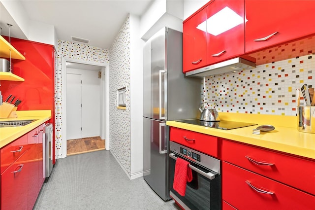 kitchen featuring stainless steel appliances, tasteful backsplash, and sink