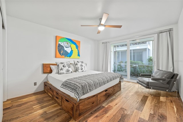 bedroom with hardwood / wood-style floors, ceiling fan, and access to exterior