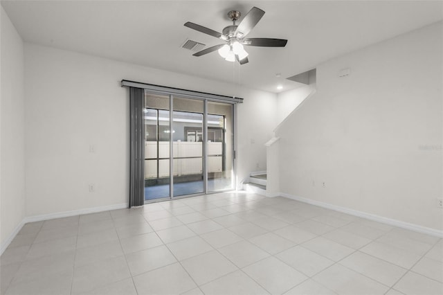 tiled empty room featuring ceiling fan