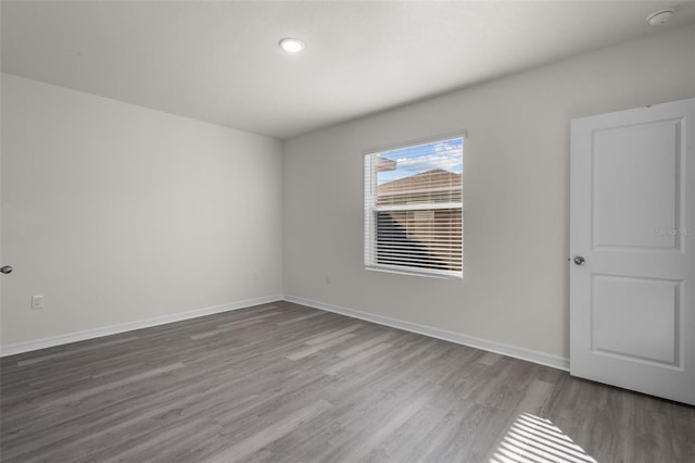 unfurnished room featuring hardwood / wood-style flooring