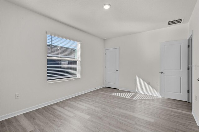 unfurnished room featuring light hardwood / wood-style floors