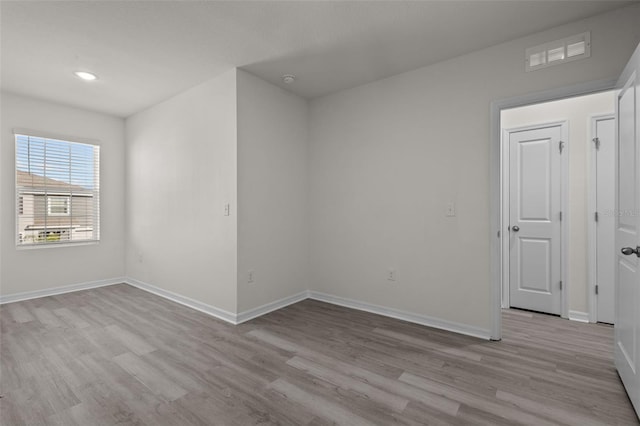 unfurnished room with light wood-type flooring