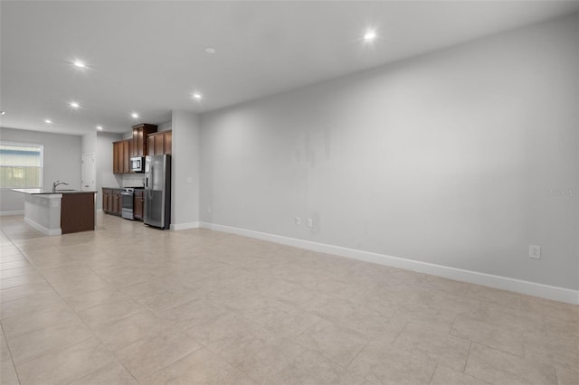 unfurnished living room featuring sink