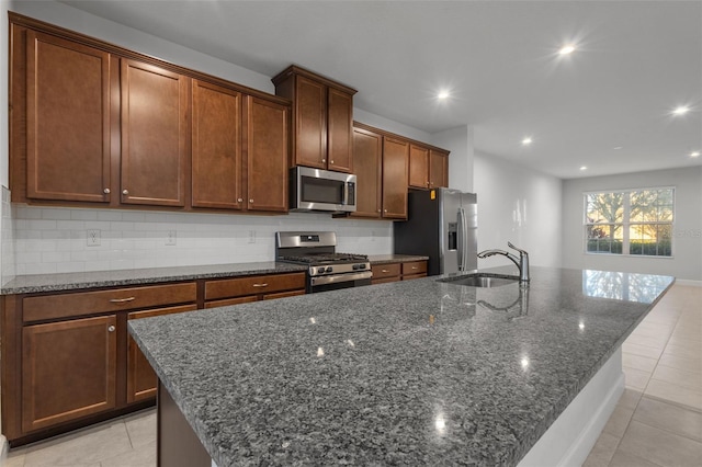 kitchen featuring a center island with sink, sink, and appliances with stainless steel finishes