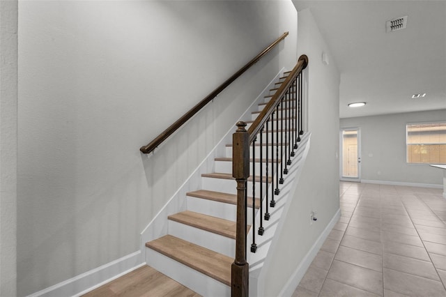 staircase with tile patterned floors