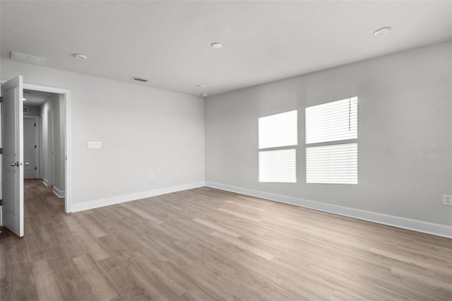 unfurnished room with light hardwood / wood-style flooring