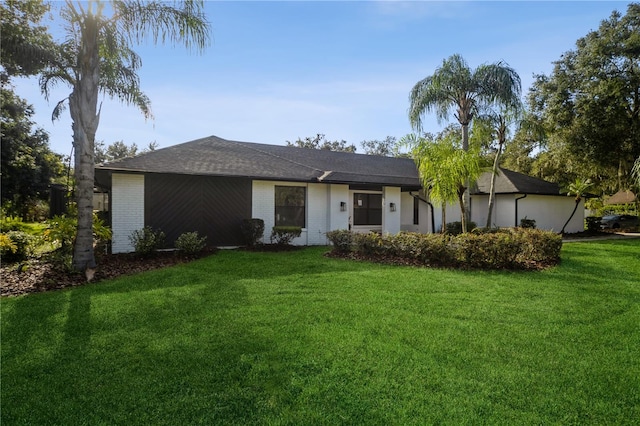 ranch-style home with a front lawn