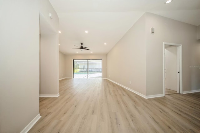 spare room with ceiling fan, light hardwood / wood-style floors, and vaulted ceiling