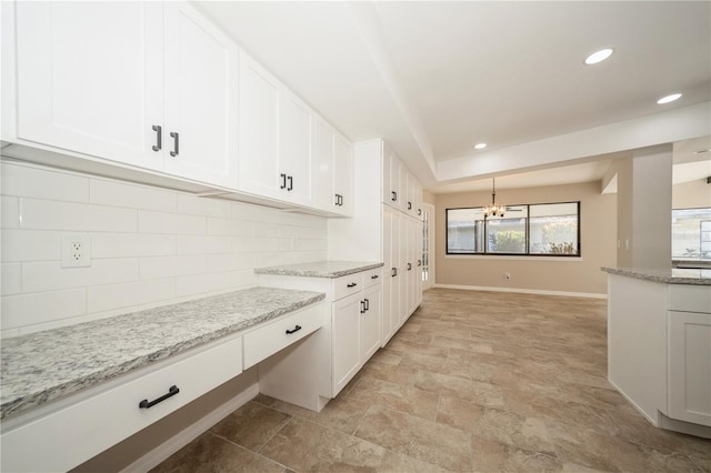 kitchen featuring tasteful backsplash, white cabinetry, and pendant lighting