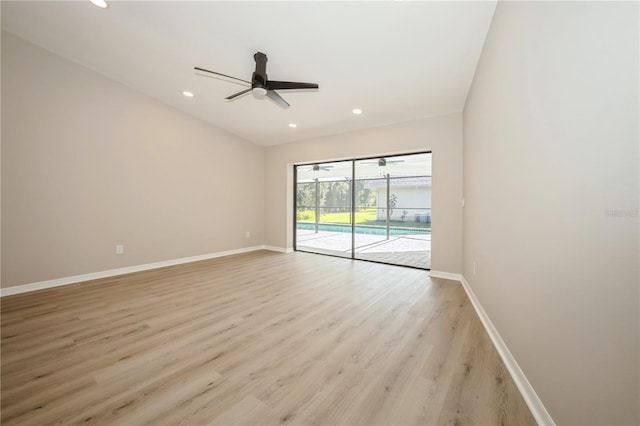 unfurnished room featuring ceiling fan, light wood-type flooring, and vaulted ceiling