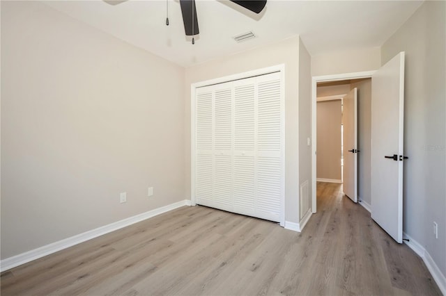 unfurnished bedroom featuring ceiling fan, a closet, and light hardwood / wood-style floors