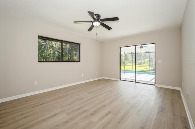 spare room featuring ceiling fan, a healthy amount of sunlight, and light hardwood / wood-style floors