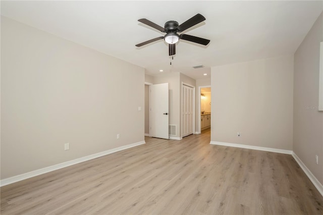 spare room featuring light hardwood / wood-style floors and ceiling fan