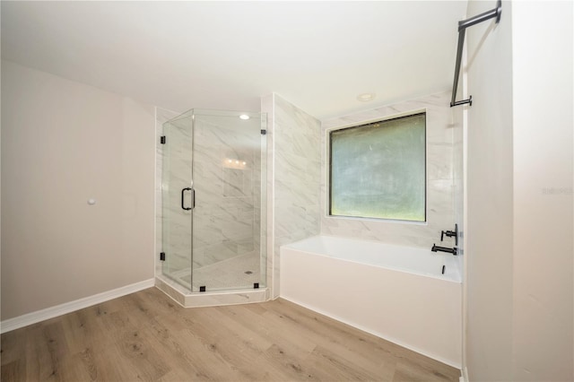 bathroom featuring separate shower and tub and wood-type flooring