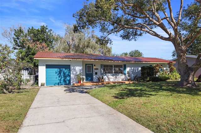 ranch-style house featuring a front yard, a porch, and a garage