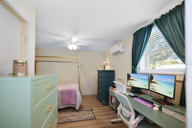 bedroom featuring ceiling fan, light hardwood / wood-style floors, and an AC wall unit