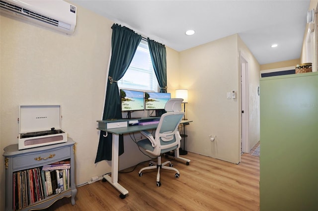 office space featuring light hardwood / wood-style floors and a wall unit AC