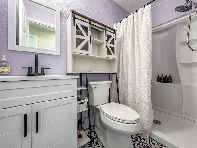 bathroom featuring toilet, tile patterned flooring, walk in shower, a textured ceiling, and vanity