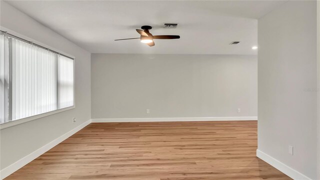 empty room with light hardwood / wood-style floors and ceiling fan